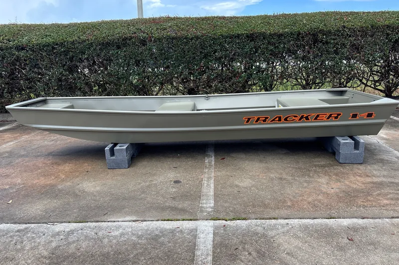 The Image of 2026 Tracker Grizzly 14 Jon boat on concrete blocks, parked outdoors. - 0