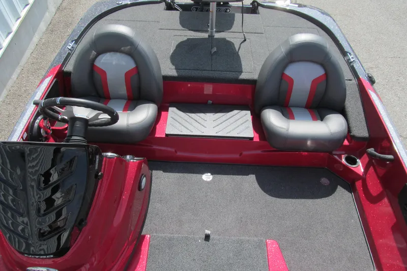 Slide: The Image of 2026 Nitro Z17 boat interior with dual gray and red seats, steering wheel, and carpeted flooring. - 100