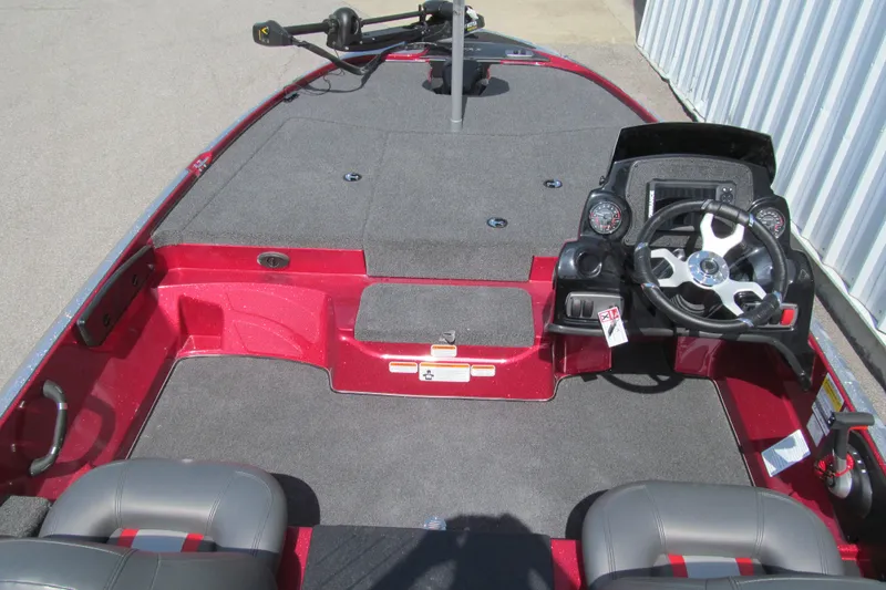 Slide: The Image of 2026 Nitro Z17 boat interior with steering wheel and seating, featuring a sleek red design. - 94