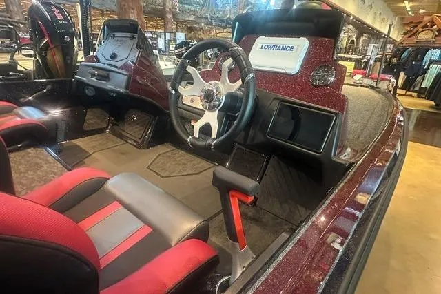 Slide: The Image of 2026 Nitro Z21 XL boat interior with steering wheel, Lowrance display, and red-accented seats. - 2