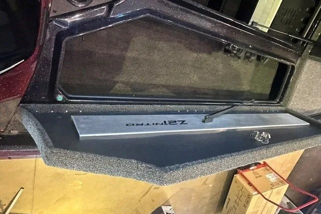 Slide: The Image of 2026 Nitro Z21 XL boat interior with storage compartment and carpeted finish. - 11