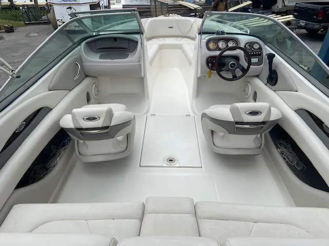 Slide: The Image of Interior of a 2006 Chaparral 210 SSi boat, white seating, visible steering console. - 9