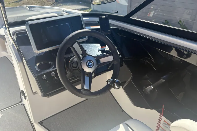 Slide: The Image of 2025 Yamaha Boats AR250 jet propulsion system, close-up view in storage area. - 21