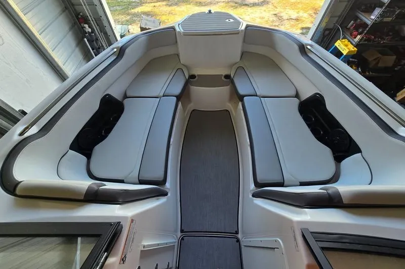 Slide: The Image of 2025 Yamaha AR250 boat on trailer beside blue building. - 4