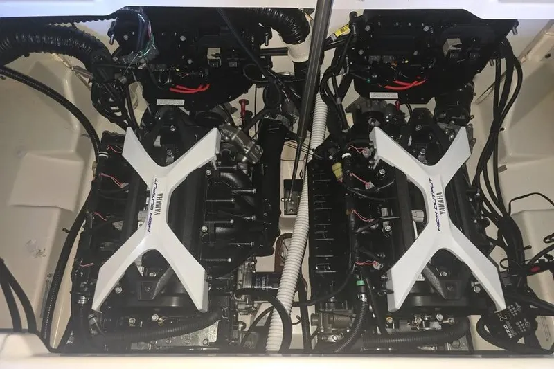 Slide: The Image of 2025 Yamaha Boats AR250 anchored near a scenic shoreline. - 6