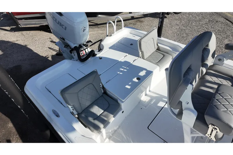 Slide: The Image of 2026 Blazer PureBay 2400 boat interior with Suzuki engine, featuring gray cushioned seating. - 10