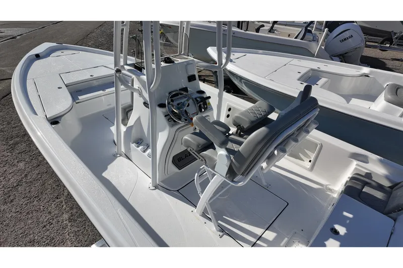 Slide: The Image of 2026 Blazer PureBay 2400 boat interior with steering console and seating. - 4
