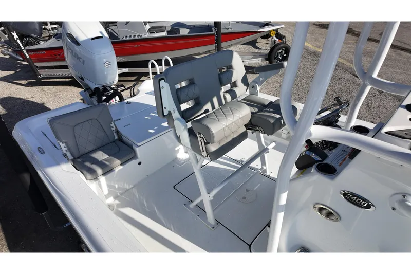 Slide: The Image of 2026 Blazer PureBay 2400 boat interior with seating and Suzuki outboard motor. - 9
