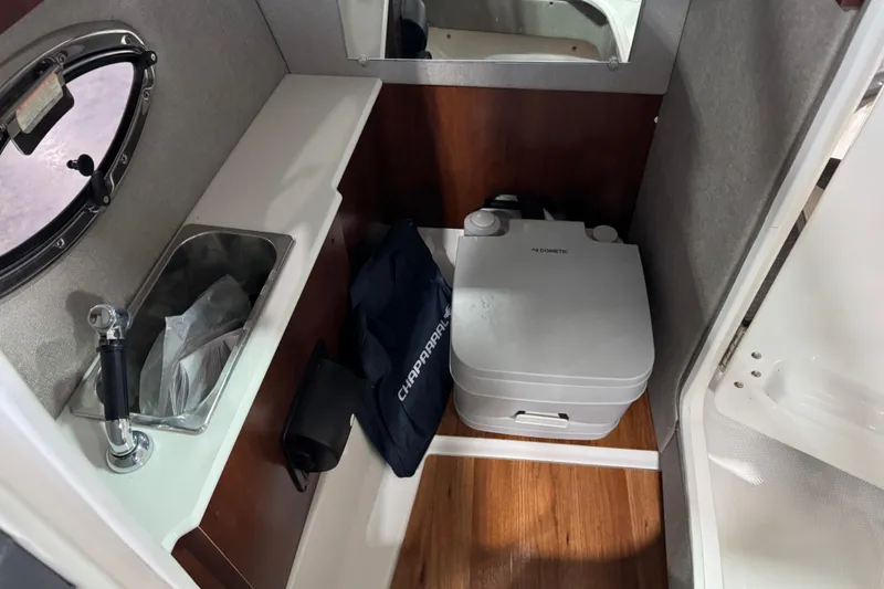 Slide: The Image of 2020 Chaparral 257 SSX boat interior with sink and portable toilet. - 16