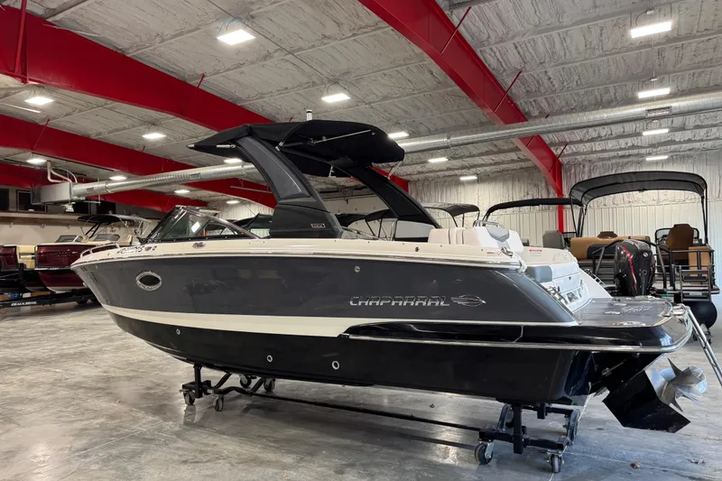 Slide: The Image of 2020 Chaparral 257 SSX boat in showroom, sleek design, black and white exterior. - 4