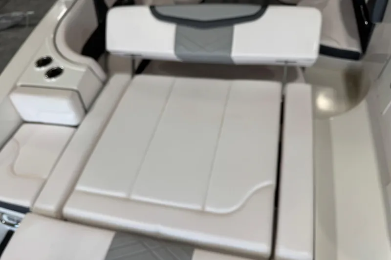 Slide: The Image of 2020 Chaparral 257 SSX boat interior with white cushioned seating and cup holders. - 7