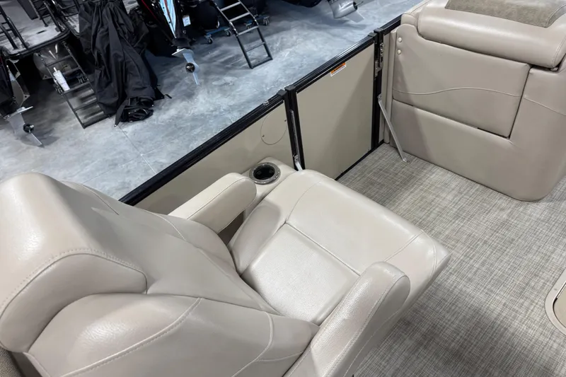 Slide: The Image of Luxurious seating on 2019 Avalon 2585 Catalina boat, featuring beige leather and cup holder. - 12