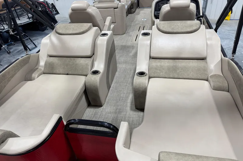 Slide: The Image of 2019 Avalon 2585 Catalina boat interior with beige seating and cup holders. - 14