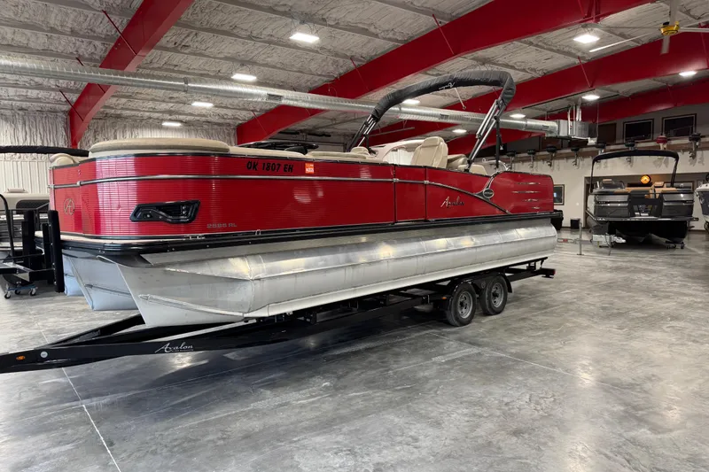 Slide: The Image of 2019 Avalon 2585 Catalina pontoon boat in showroom on trailer. - 2