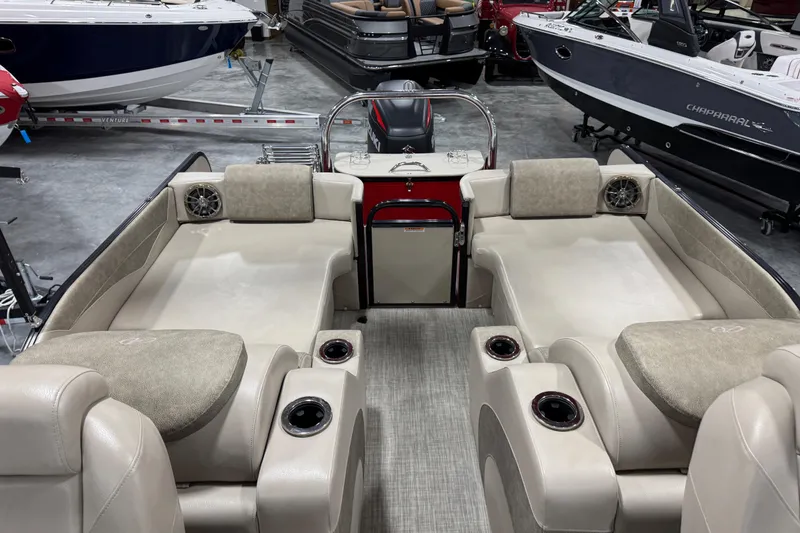 Slide: The Image of 2019 Avalon 2585 Catalina boat interior with beige seating and cup holders in showroom. - 9