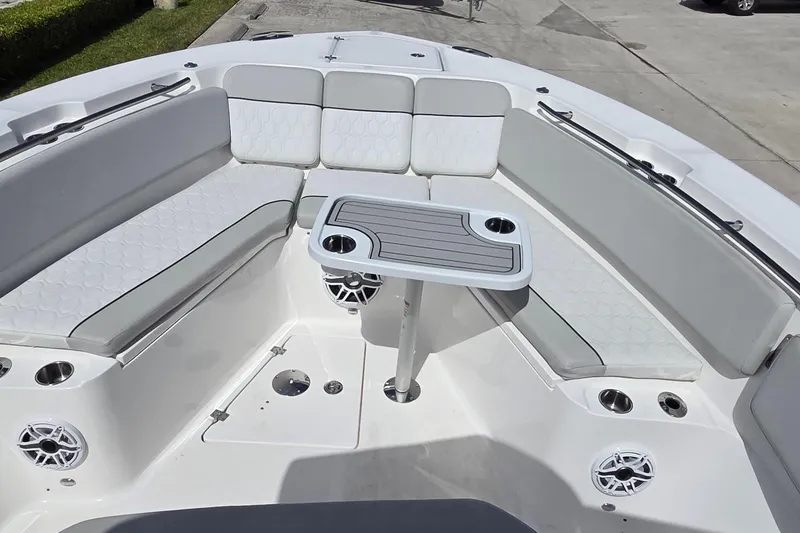 Slide: The Image of 2022 Sea Fox 328 Commander boat interior with cushioned seating and table. - 23