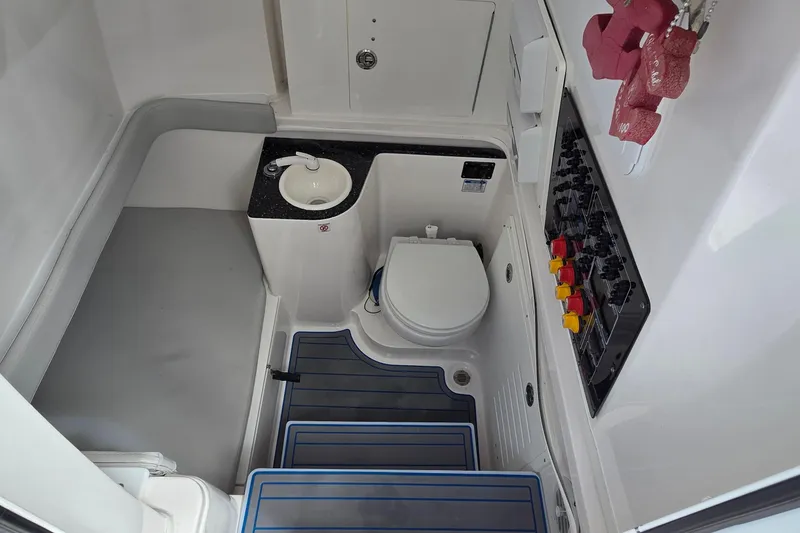 Slide: The Image of 2022 Sea Fox 328 Commander boat interior with toilet, sink, and control panel. - 26