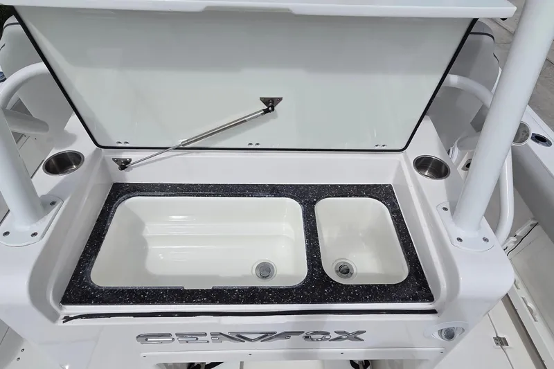 Slide: The Image of 2022 Sea Fox 328 Commander boat sink and storage area with dual compartments. - 30