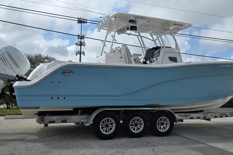 Slide: The Image of 2022 Sea Fox 328 Commander boat on trailer, light blue hull, dual Mercury engines. - 39