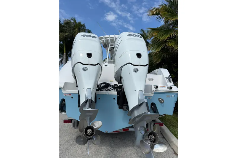 Slide: The Image of 2022 Sea Fox 328 Commander with twin 400 horsepower engines, parked near palm trees. - 4