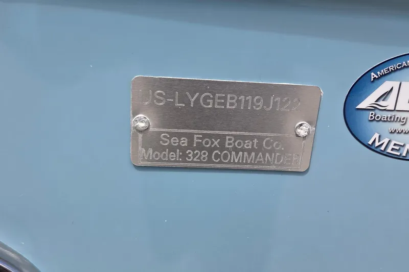 Slide: The Image of 2022 Sea Fox 328 Commander boat identification plate on blue surface. - 41