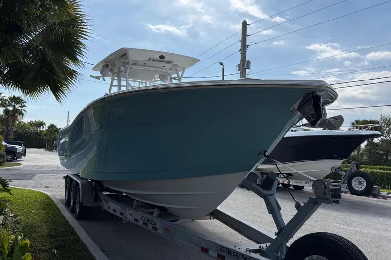 Slide: The Image of 2022 Sea Fox 328 Commander boat on trailer, parked outdoors under a clear sky. - 5