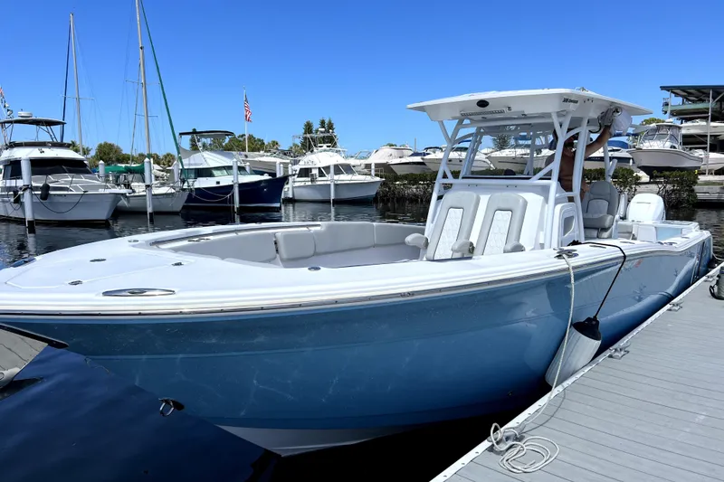 Slide: The Image of 2022 Sea Fox 328 Commander boat docked at marina under clear blue sky. - 7