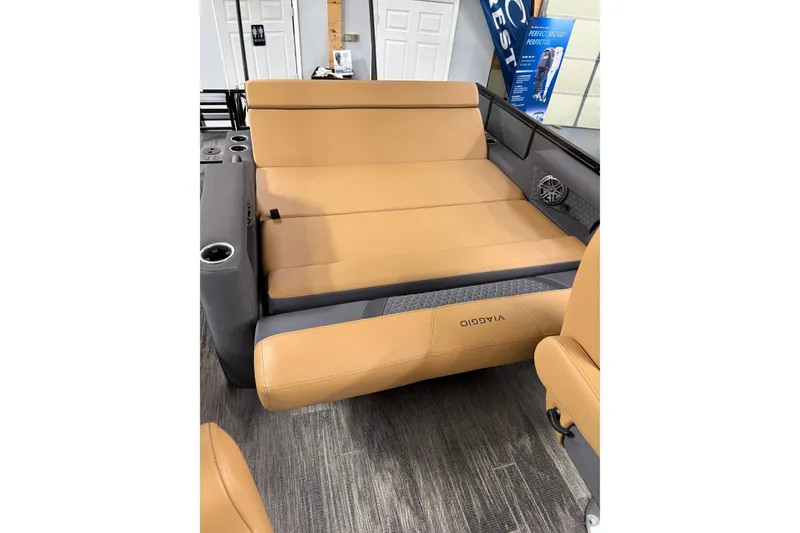 Slide: The Image of 2025 Viaggio Z22S interior with tan leather seating and cup holders. - 37