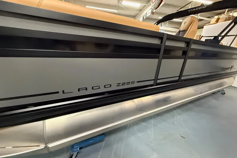 Slide: The Image of 2025 Viaggio Z22S pontoon boat in showroom, featuring sleek design and modern seating. - 4