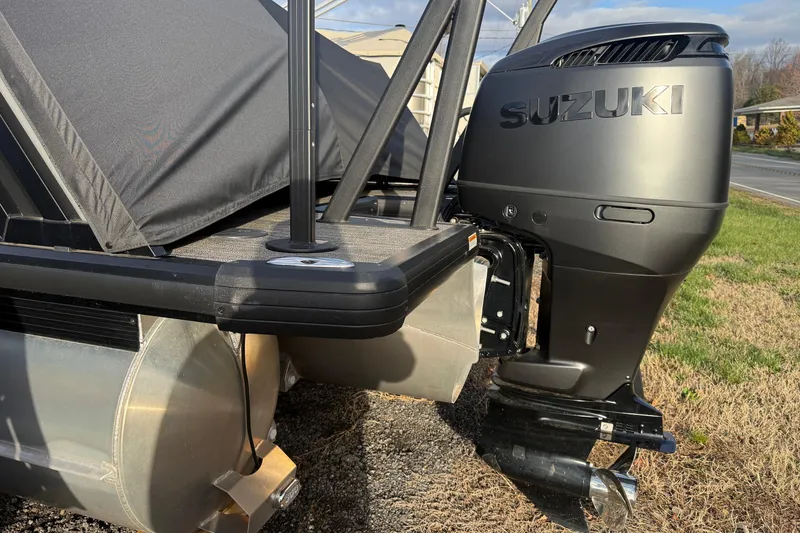 Slide: The Image of 2025 Viaggio Z22S pontoon boat with Suzuki outboard motor, parked on grass. - 54