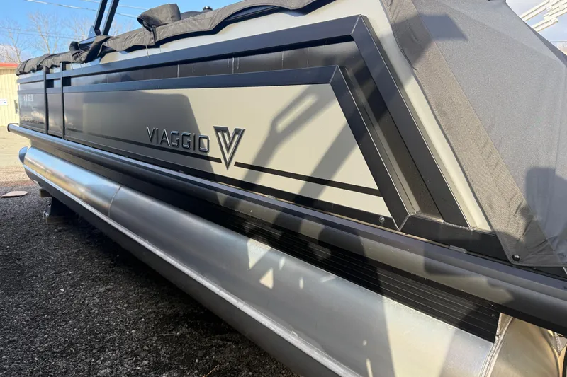 Slide: The Image of 2025 Viaggio Z22S pontoon boat with sleek design and protective cover. - 55