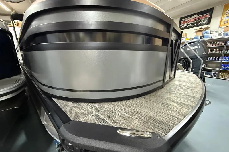 Slide: The Image of 2025 Viaggio Z22S pontoon boat with sleek metallic design in showroom. - 8