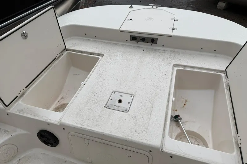 Slide: The Image of 2022 Carolina Skiff 23 LS boat deck with storage compartments and utility features. - 11