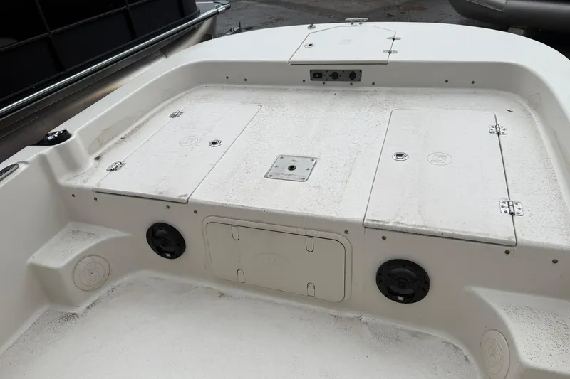 Slide: The Image of 2022 Carolina Skiff 23 LS boat deck with storage compartments and speakers. - 12