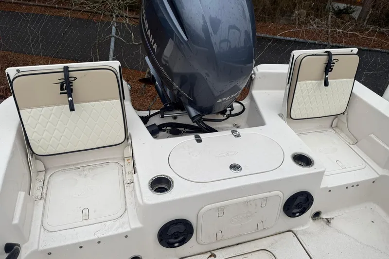 Slide: The Image of 2022 Carolina Skiff 23 LS boat interior with Yamaha engine and storage compartments. - 5