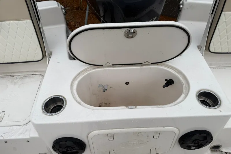 Slide: The Image of 2022 Carolina Skiff 23 LS boat with open storage compartment and cup holders. - 6