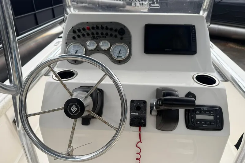 Slide: The Image of 2022 Carolina Skiff 23 LS boat dashboard with steering wheel and control panel. - 7