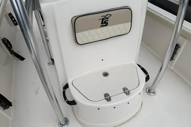 Slide: The Image of 2022 Carolina Skiff 23 LS boat interior with storage compartment and padded seat. - 8