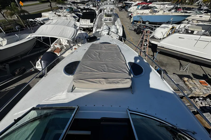 Slide: The Image of 2005 Cobolt 36 yacht in a marina, surrounded by other boats. - 16