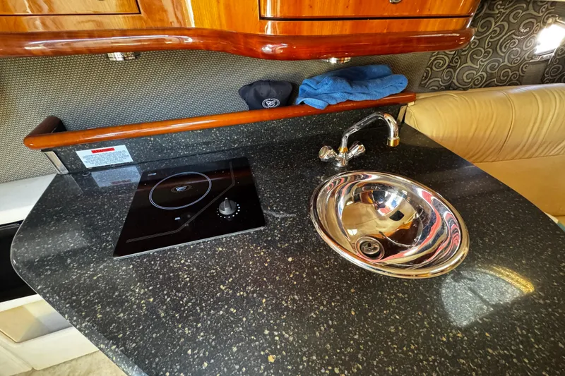 Slide: The Image of Compact kitchen area in a 2005 Cobolt 36 boat with sink and stove. - 21