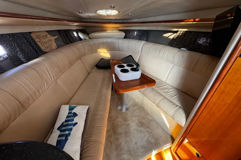 Slide: The Image of Luxurious interior of a 2005 Cobolt 36 boat with beige seating and wooden table. - 22
