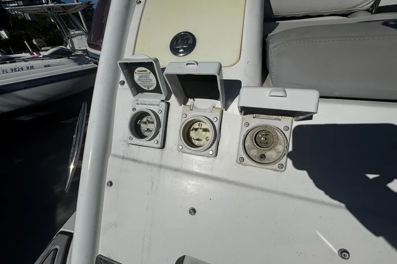 Slide: The Image of Boat electrical outlets on a 2005 Cobolt 36, featuring three covered sockets. - 4