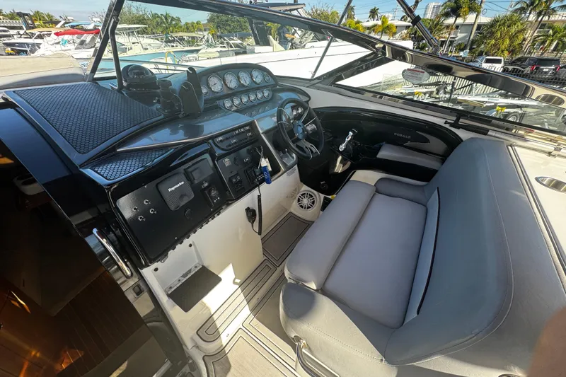 Slide: The Image of Interior of a 2005 Cobolt 36 boat with dashboard and seating area. - 9