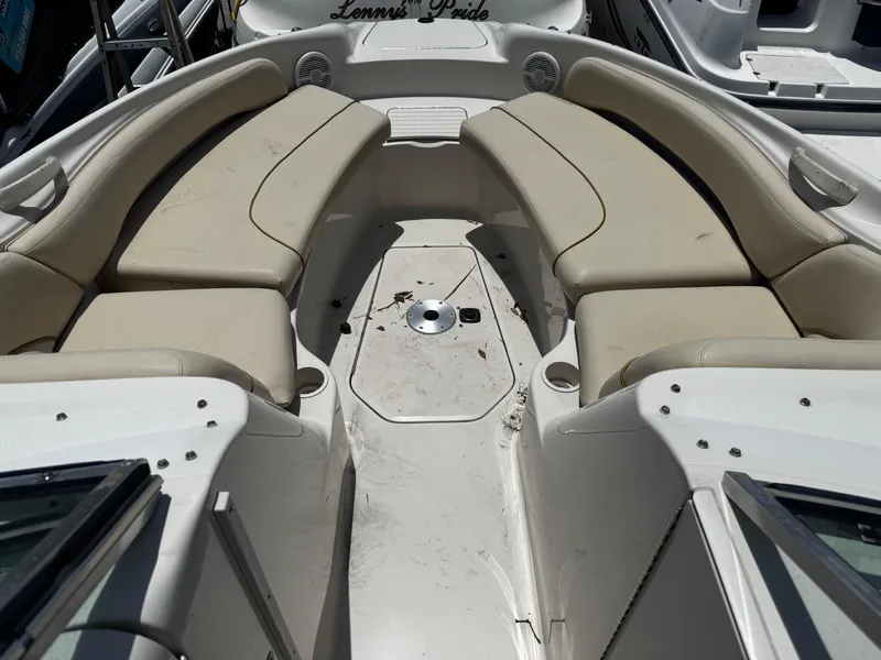 Slide: The Image of 2001 Sea Ray 240 Sundeck boat interior with beige seating and spacious layout. - 9