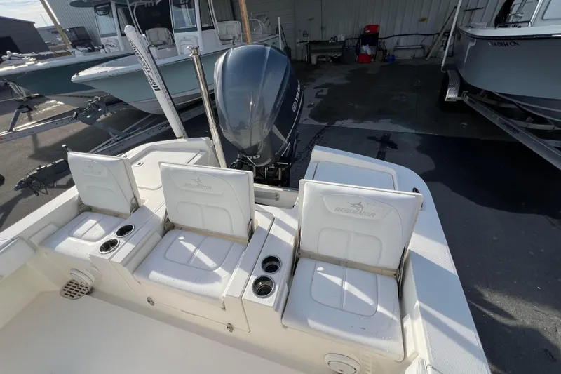 Slide: The Image of 2019 Regulator 26XO boat with Yamaha engine, featuring rear seating and cup holders. - 16