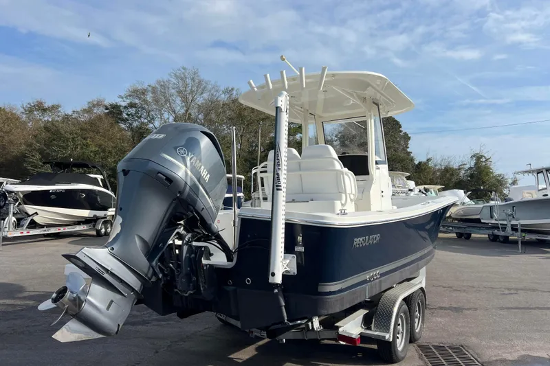 Slide: The Image of 2019 Regulator 26XO boat with Yamaha outboard motor, parked on a trailer. - 5