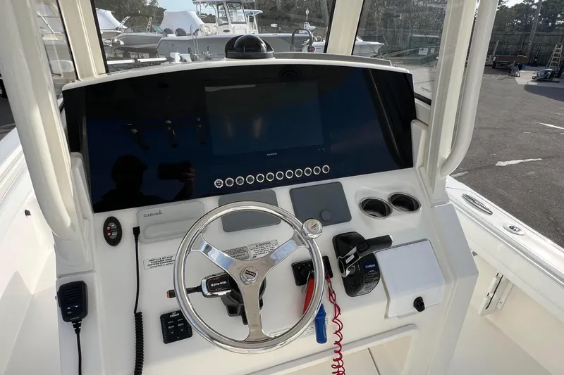 Slide: The Image of 2019 Regulator 26XO boat dashboard with steering wheel and navigation controls. - 9