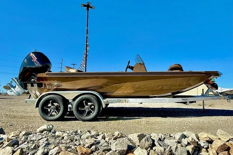 The Image of 2026 Thor Lake Hammer 1900SC boat on trailer, parked outdoors under clear blue sky. - 1