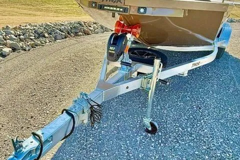 Slide: The Image of 2026 Thor Lake Hammer 1900SC boat trailer on gravel path. - 7