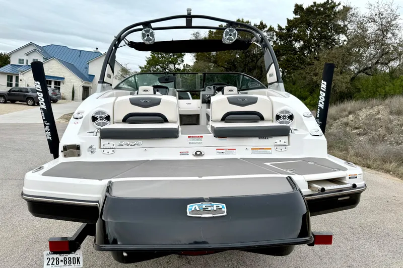 Slide: The Image of 2018 Chaparral Vortex 2430 VRX boat, rear view, parked on a driveway. - 11
